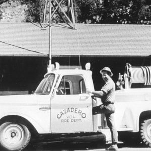 Volunteer Fireman Stepping into an Old Fire Truck in Cazadero 1968