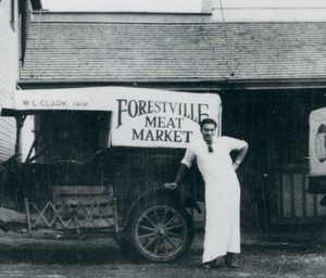 A Butcher Leaning on His Forestville Meat Market Delivery Wagon