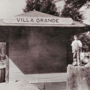 Boy Standing on a Large Redwood Tree Stump with His Friend at the Villa Grande Train Station